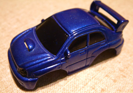 blue subaru.
this WRX was painted using a primer, then metalic purple undercoat, blue transparent gloss and then a coat of clear gloss. 
   all tamiya spray, every coat allowed to dry before the next one was applied.
